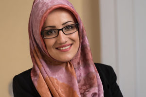 A lady in a hijab smiling