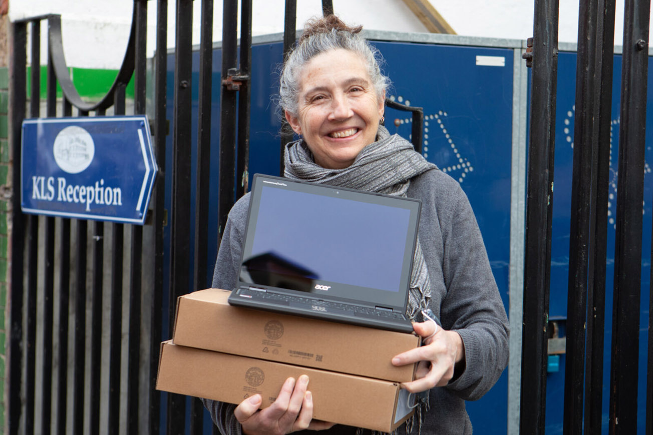 A woman holding a laptop.