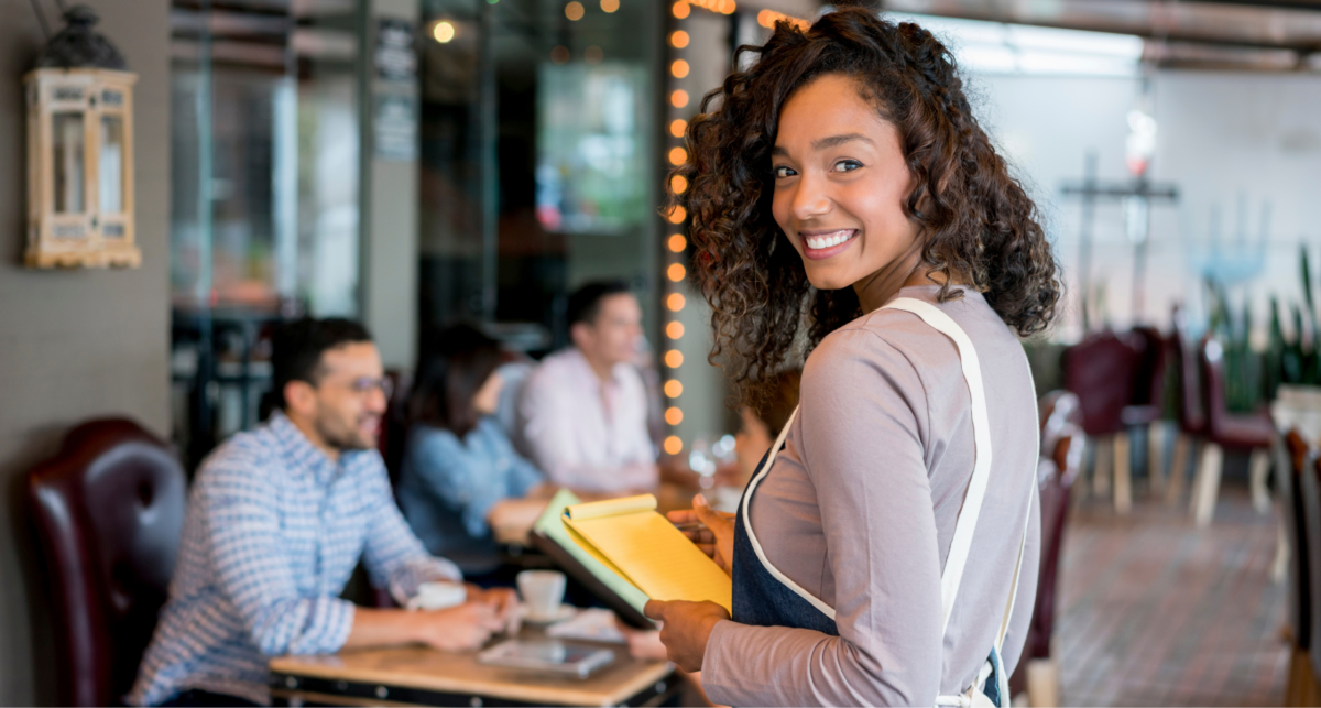 A smiling woman, working in hospitality